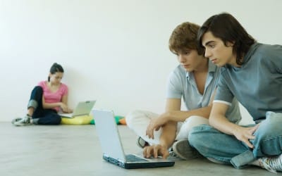 Teenagers using laptops